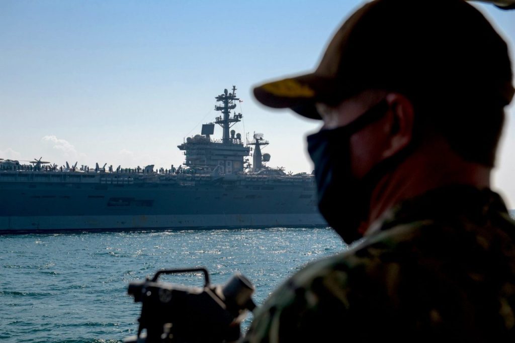 Vice Adm. Samuel Paparo, commander of U.S. Naval Forces Central Command, U.S. 5th Fleet and Combined Maritime Forces, watches the aircraft carrier USS Nimitz (CVN-68) from the bridge wing of the coastal patrol ship USS Squall (PC-7) in the Persian Gulf on Nov. 8, 2020. US Navy Photo