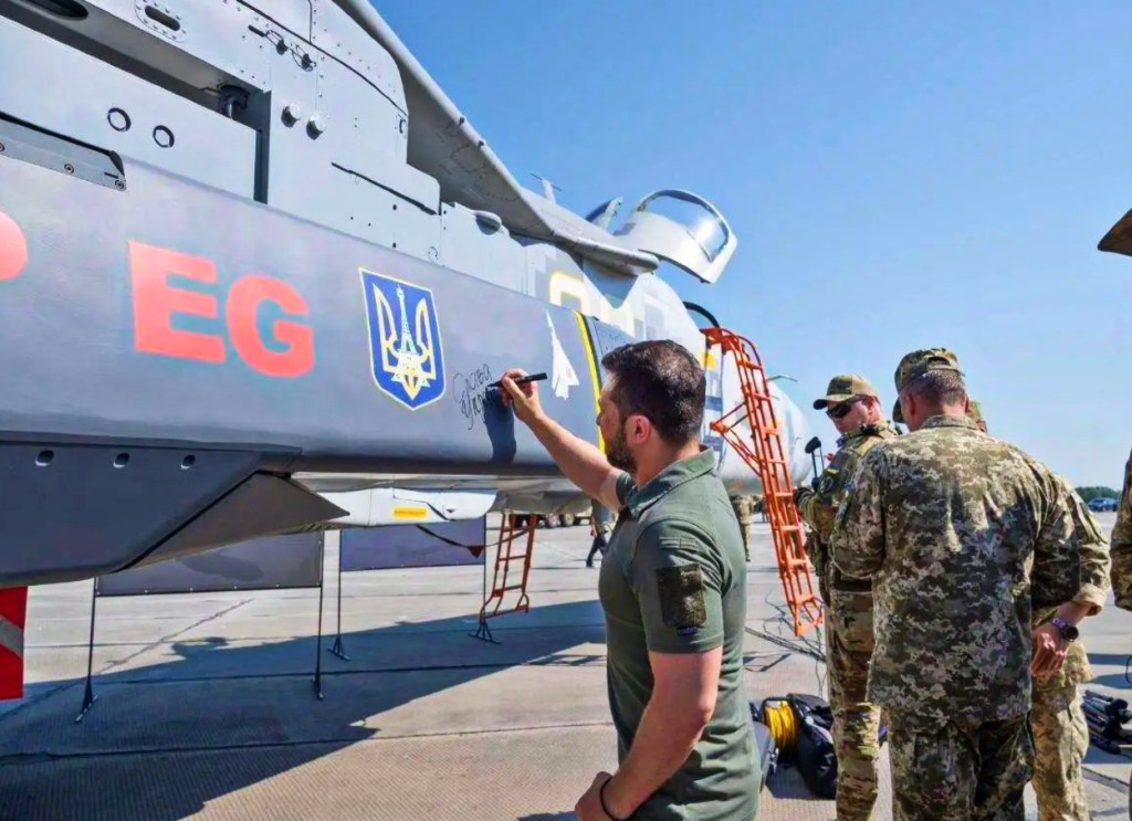 Zelensky can be seen signing a SCALP-EG missile